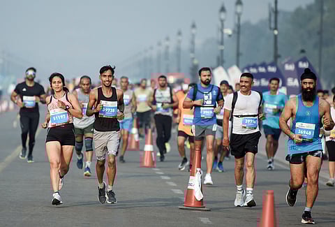 Participants take part in the 'Vedanta Delhi Half Marathon' at India Gate, in New Delhi on Sunday.