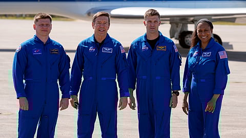 The SpaceX crew of the Dragon spacecraft, from left, cosmonaut Alexander Grebenkin, pilot Michael Barratt, commander Matthew Dominick and mission specialist Jeanette Epps gather for a photo after arriving at the Kennedy Space Center in Cape Canaveral