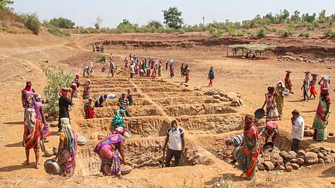 Labourers work at a construction site under the MGNREGA scheme.