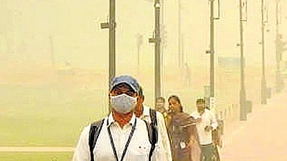 People wear mask to walk through streets of Delhi amid air pollution surge.