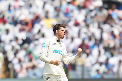 New Zealand players celebrate Rohit Sharma’s wicket in Pune on Saturday 