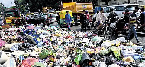 Heap of garbage uncleared on 80 feet road Koramangala, in Bengaluru on Monday. 