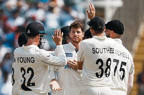 New Zealands Mitchell Santner celebrates with teammates after taking the wicket of Indias captain Rohit Sharma on the third day of the second test cricket match between India and New Zealand in Pune, Saturday, Oct. 26, 2024. 