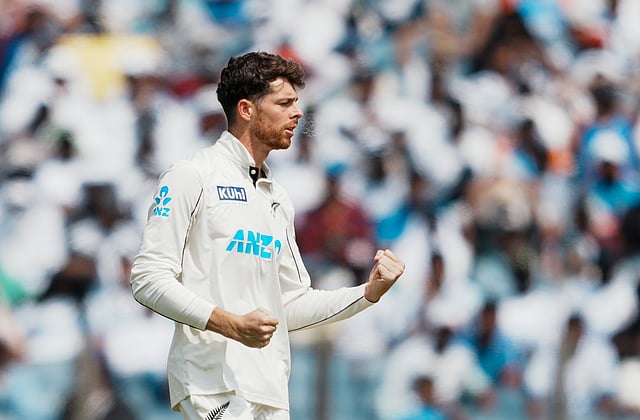Mitchell Santner celebrates the wicket of  Rohit Sharma during the second Test in Pune.