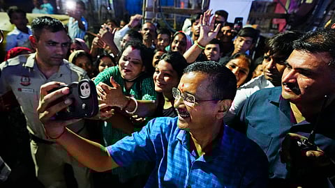 Aam Aadmi Party (AAP) National Convenor Arvind Kejriwal clicks a selfie with people during a Padyatra, at Wazirpur in New Delhi on Sunday.