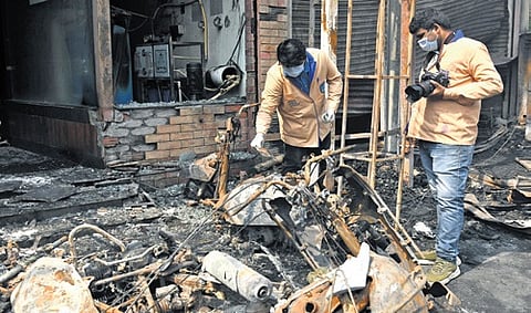 The clues team collects samples from the site of the fire mishap..