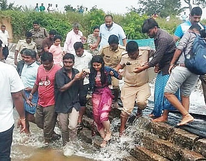 Rescuers pull out Hamsa S Gowda to safety after she fell into a 15-foot gorge at the sluice of Mydala tank 