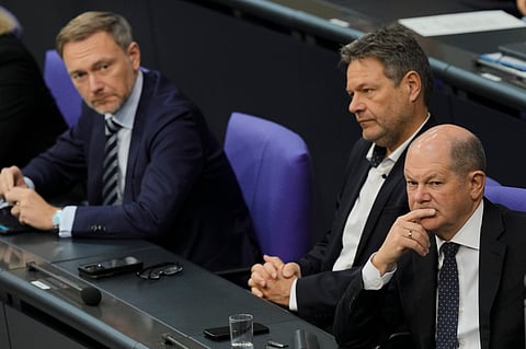 German Chancellor Olaf Scholz, from right, Economy and Climate Minister Robert Habeck and Finance Minister Christian Lindner listen to a debate about Germany's budget crisis at the parliament Bundestag in Berlin, Germany, Tuesday, Nov. 28, 2023.