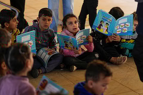Displaced children, who fled Baalbek city and the nearby towns of Douris and Ain Bourday with their families amid the ongoing Hezbollah-Israel war, study inside at a school being used as a shelter, in Deir Al-Ahmar, east Lebanon, Thursday, Oct. 31, 2024.