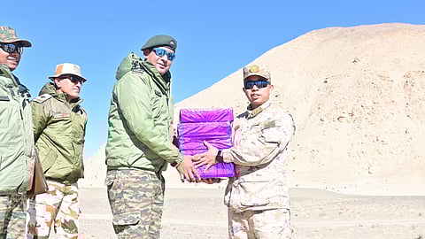 Soldiers of the Indian and Chinese Army exchange sweets at the Chushul-Moldo border meeting point on the occasion of Diwali on Thursday, Oct. 31, 2024.