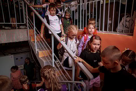 Children from Gymnasium No. 6 head to a basement set up with classrooms during an air alert in Zaporizhzhia, Ukraine, Sept. 3, 2024. The city is building a dozen subterranean schools designed to be radiation- and bomb-proof.