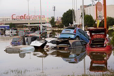Cars are seen half submerged after floods in Valencia, Spain, Friday, Nov. 1, 2024.