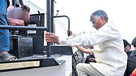 Chief Minister N Chandrababu Naidu boarding a road roller to carry out road repair works at Vennelapalem village in Anakapalli district on Saturday 