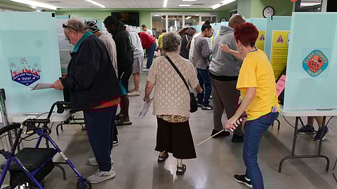 A voter is directed to an available voting booth at the Silverado Ranch Community Center, Saturday, Oct. 19, 2024, in Las Vegas.