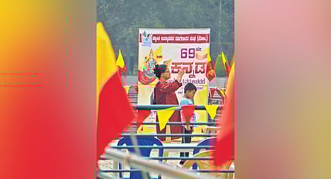 A woman and her son enjoy an outing at Sankey Tank that has been decorated with Kannada flags 