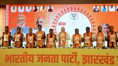 Union Minister and senior BJP leader Amit Shah with Jharkhand BJP President Babulal Marandi and other leaders releases the party's Sankalp Patra (election manifesto) for the upcoming Assembly elections, in Ranchi.