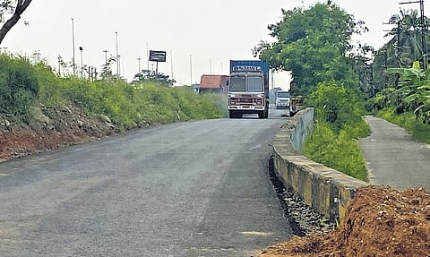 A container truck proceeds via the new service road near Vallarpadam