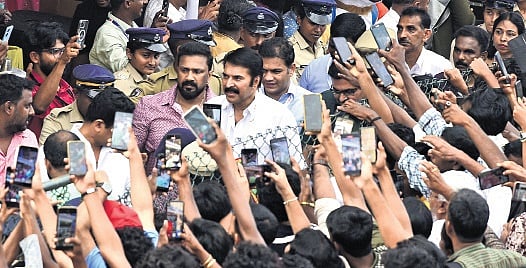 Spectators taking a snap of Mammootty