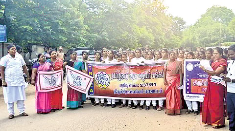 Healthcare workers staging a protest in Tiruchy on Monday 