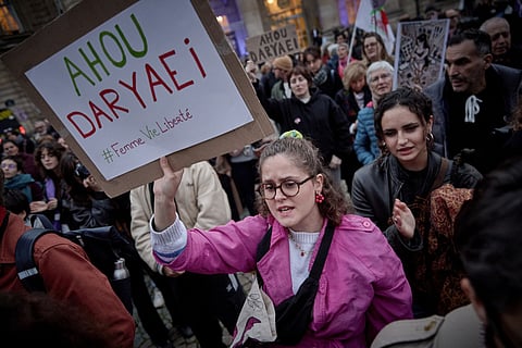 Women take part in a protest gathering called by the "Woman Life Freedom Collective" (Femme Vie Liberte) and the Association Phenix, in support of the Iranian student arrested after stripping to her underwear in Tehran, by the Pantheon monument near the Sorbonne University in Paris on November 5, 2024.