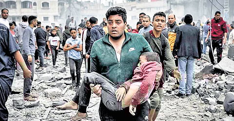 A man carries his wounded son in Gaza