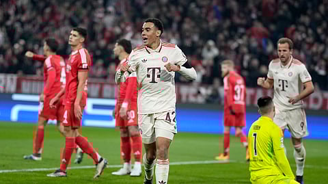 Bayern's Jamal Musiala celebrates after scoring the opening goal during the Champions League opening phase football match between Bayern Munich and SL Benfica, in Munich.
