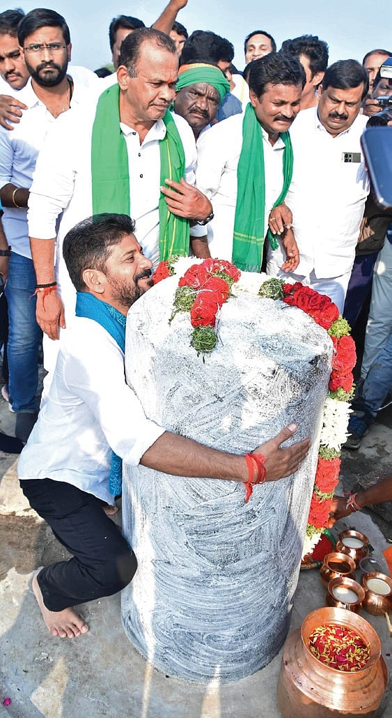 Chief Minister A Revanth Reddy embraces a Shivalingam on the banks of Musi before starting his padayatra at Sangem in Yadadri-Bhuvanagiri district on Friday