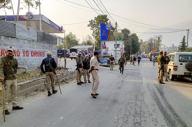 Security personnel stand guard on a road after Sanatan Dharam Sabha called for a district-wide bandh in protest against the killing of two Village Defence Guards by terrorists on Thursday, in Kishtwar district, Jammu & Kashmir. 