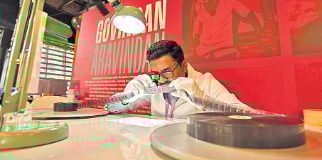 A technician examining a film reel at the Film Preservation and Restoration Workshop India, underway at Vyloppilli Samskrithi Bhavan in Thiruvananthapuram 