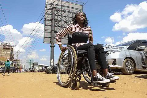 Carol Mwikali rides around on a wheelchair in Nairobi, Kenya, Wednesday, Oct. 9, 2024.