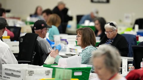 Election workers process ballots at the Maricopa County Tabulation Center Wednesday.