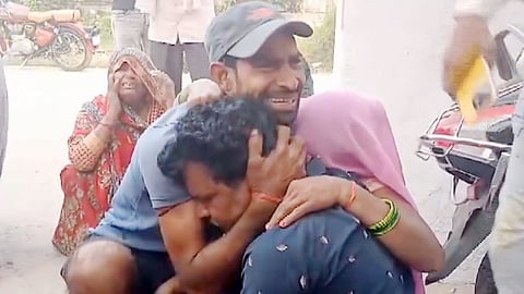 People mourn the death of a relative in a raw sand mound collapse incident, in Kasganj, Uttar Pradesh.