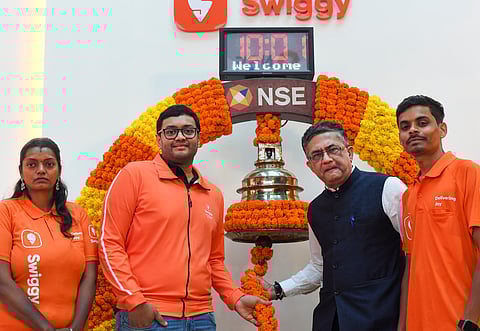 Swiggy Ltd.CEO Sriharsha Majety, National Stock Exchange MD & CEO Ashishkumar Chauhan with delivery boys at the Swiggy bell ringing listing ceremony, at the National Stock Excgange, in Mumbai, Wednesday, Nov. 13, 2024.