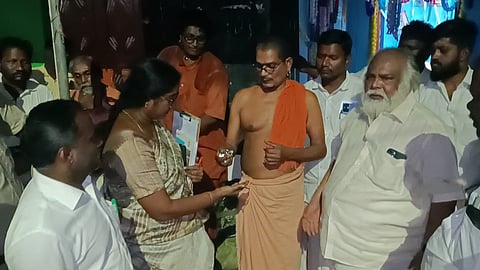 Suriyanarkoil Pontiff Sri Mahalinga Pandara Sannidhi handing over charges to Inspector of HR and CE T Aruna on Tuesday night.