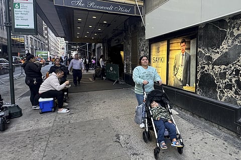 Maribel Hidalgo, 23, an immigrant from Venezuela, pushes a stroller carrying her son, Daniel, 2, outside the Roosevelt Hotel immigration shelter in New York on Wednesday, Nov 6, 2024.