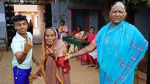 Nonagenarian Hulegamma shows her inked finger after voting in Sandur town on Wednesday.