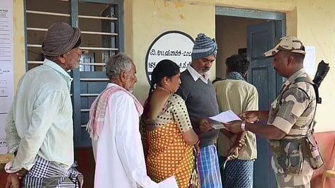Voters stand in a long queue to exercise their franchise in Channapatna on Wednesday .