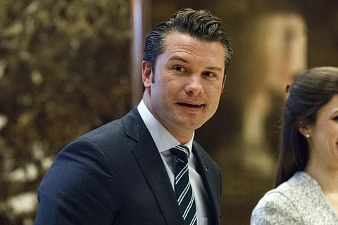 Pete Hegseth walks to an elevator for a meeting with President-elect Donald Trump at Trump Tower in New York, Dec 15, 2016.