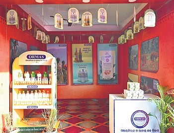 A stall by ORMAS displaying lemongrass products at the Pallishree Mela