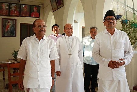 IUML leaders Panakkad Syed Sadiq Ali Shihab Thangal and P K Kunhalikutty, with Bishop Varghese Chakkalakal, following a meeting at the Varapuzha archdiocese headquarters in 2024.