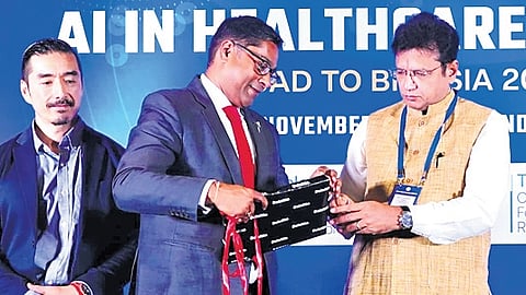 Minister D Sridhar Babu unveils the Life Sciences GCC Consortium logo during a AI Summit on Healthcare on Monday