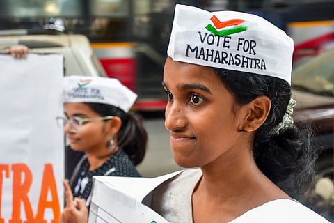 A student of an art school urges citizens to cast their votes in the upcoming Maharashtra Assembly elections, at Lalbaug, in Mumbai, Tuesday, Nov. 19, 2024.