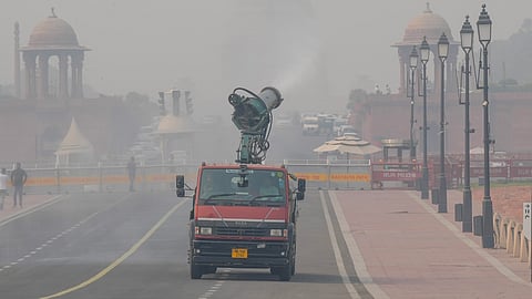 An anti-smog gun sprays mist to mitigate smoggy conditions, in New Delhi.