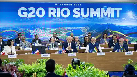 US President Joe Biden (C), alongside Indian Prime Minister Narendra Modi and Brazilian President Luiz Inácio Lula da Silva, speaks during the second day of the G20 Summit at the Museum of Modern Art in Rio De Janeiro, Brazil, November 19, 2024. 