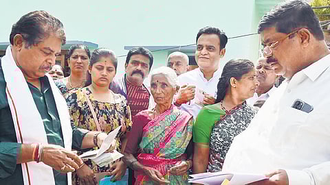 Opposition leader R Ashoka, MLAs K Gopalaiah and C N Ashwath Narayan 
listen to residents whose BPL cards were cancelled, at Nanjappa Layout in Bengaluru on Wednesday