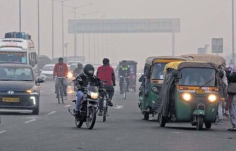 People commute amid smoggy conditions on Tuesday.