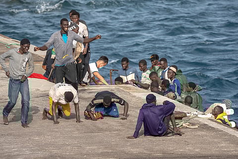 Migrants react as they arrive at the port in La Restinga on the Canary island of El Hierro, Spain,
