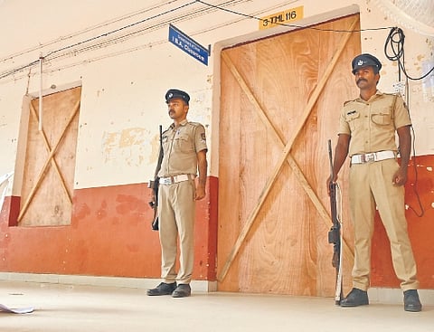 Police personnel guard the strongroom at Government Victoria College where electronic voting machines have been stored after the bypoll in Palakkad