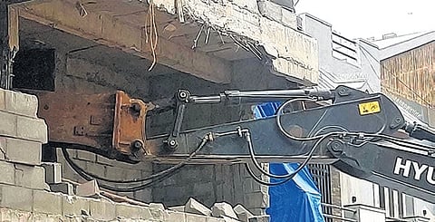 Police stop the demolition of a house by BDA, which was in progress in OMBR Layout in Bengaluru on Thursday 