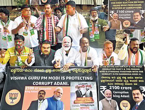 Congress workers protest against PM Narendra Modi, alleging he is ‘protecting’ industrialist Gautam Adani, in Bengaluru on Friday 